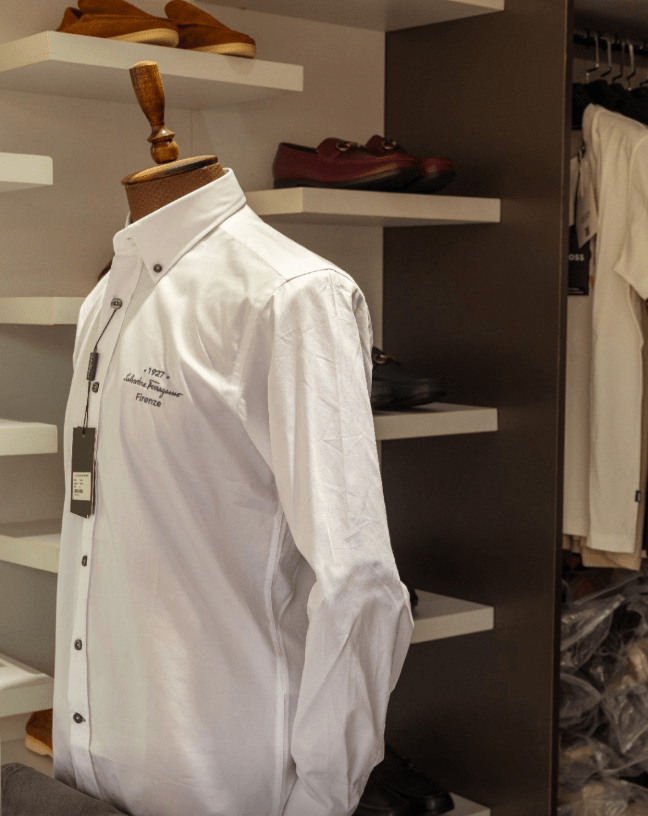 White button-down shirt on a mannequin in a clothing store